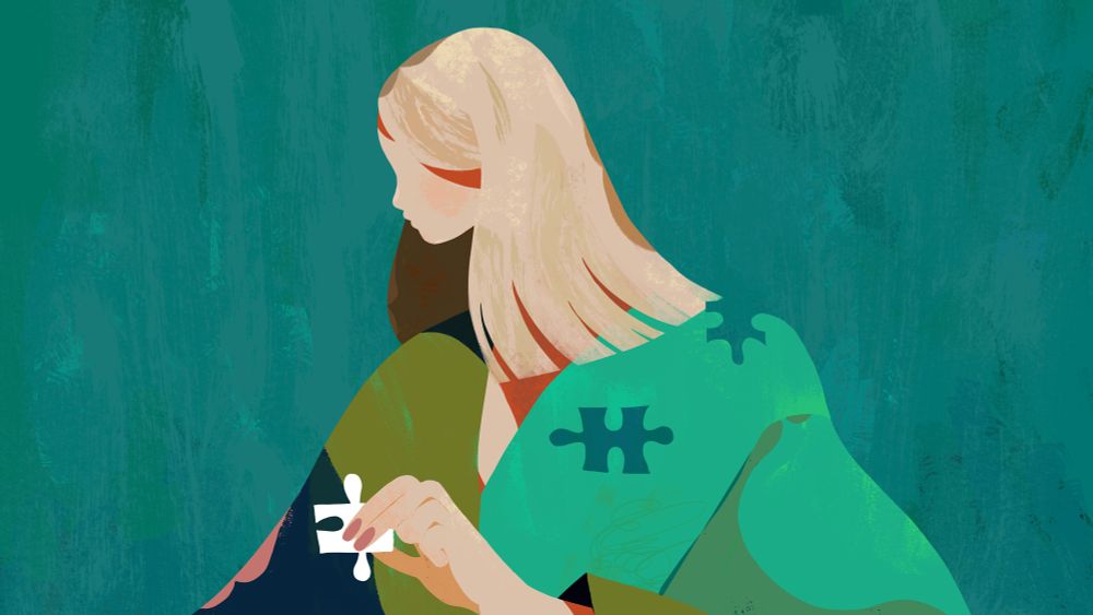 a person with missing puzzle pieces holding a piece in her hand