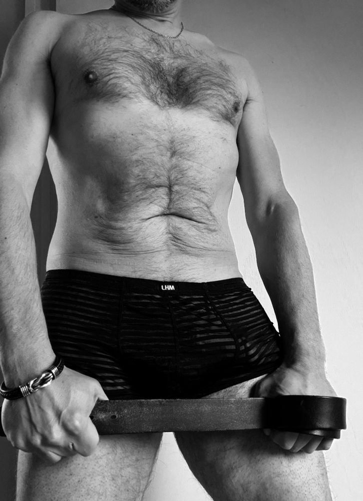 A man standing in just a pair of mesh trunks, gripping a leather belt between his clenched hands
Ready for his good girl
Ready to make her feel like the centre of the universe