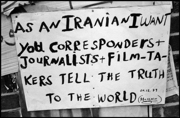 Handwritten poster reading: "as and Iranian Inwant you corresponders + journalists + film-takers tel the truth to the world." 