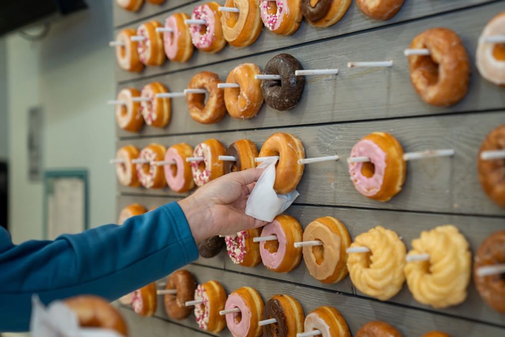 Donut wall with someone grabbing a donut 
