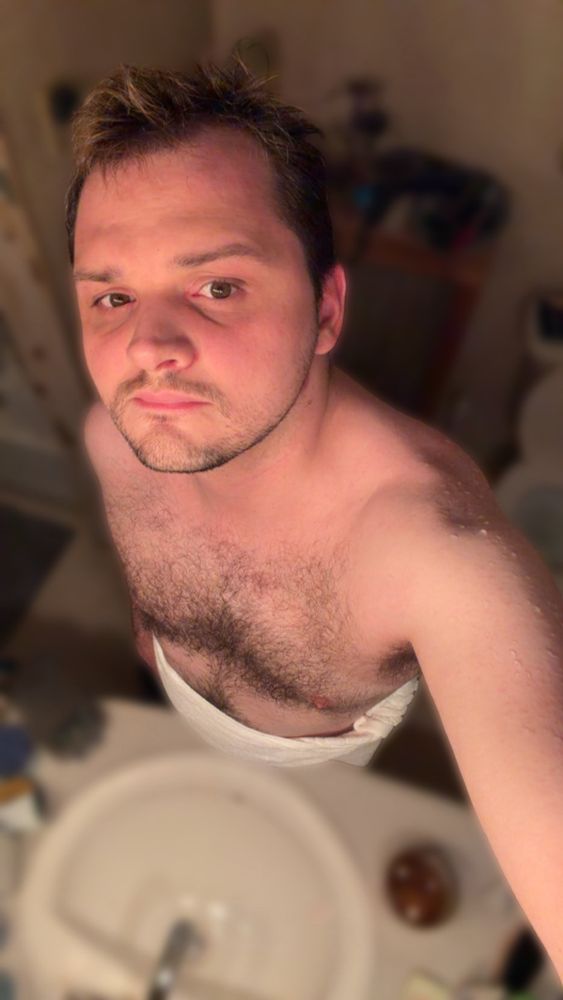 Me in a towel with water on my shoulder 