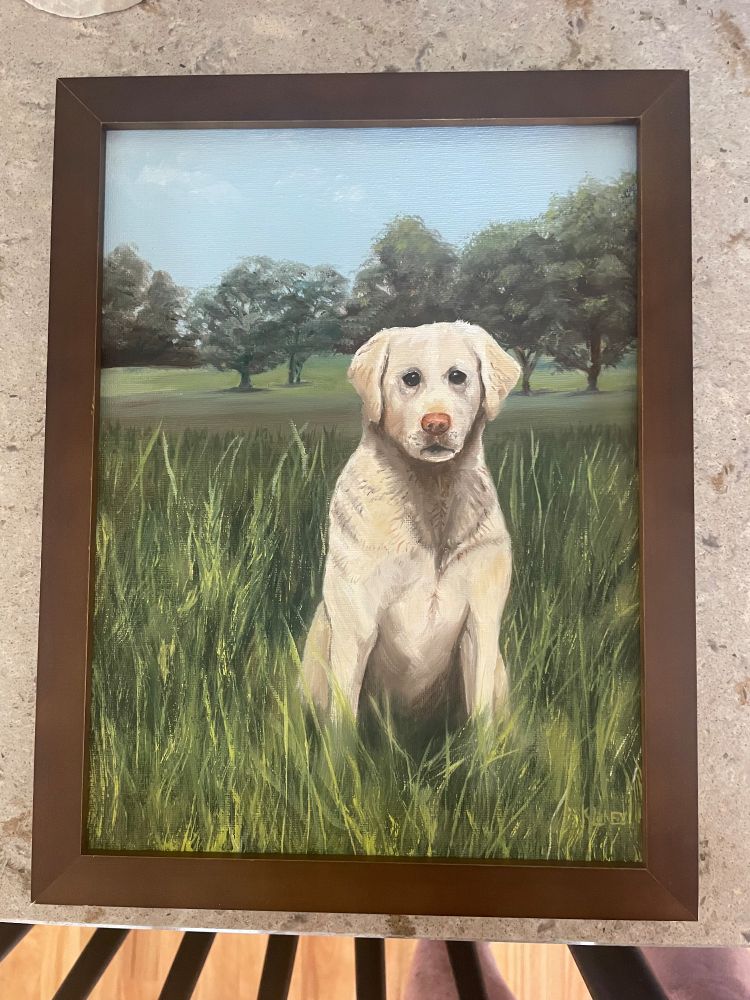 A painting of a yellow lab sitting in a prairie with trees in the background.  