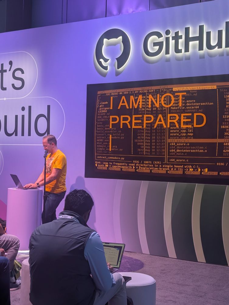 Scott Hanselman at the GitHub demo stage with a terminal app with I AM NOT PREPARED on the screen