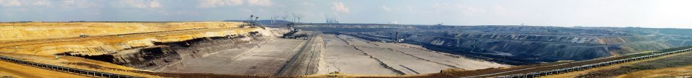 Panoramic photo of a huge open pit coal mine.