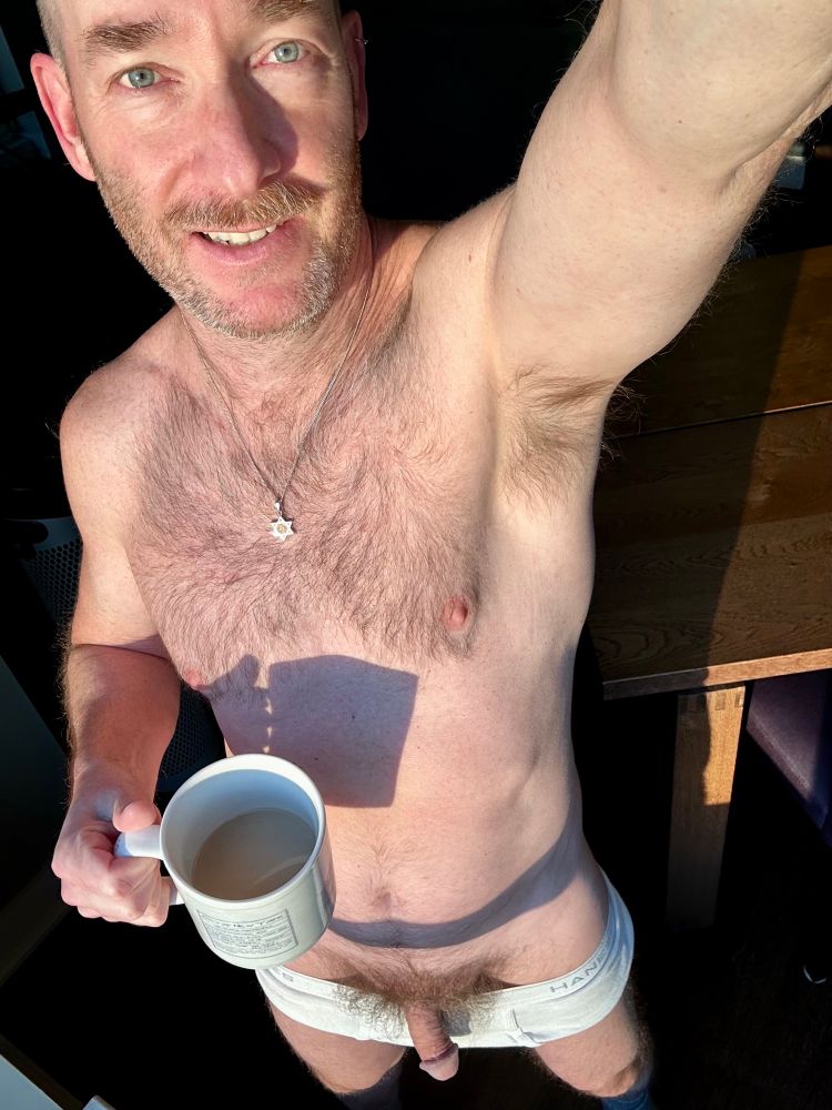 Full-body selfie holding a cup of coffee. Tighty whities pulled down in front and my hairy penis flopped over the waistband. 