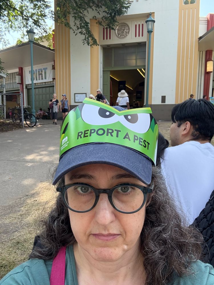 Fair selfie with a MN DNR “Report a pest” crown over my baseball cap