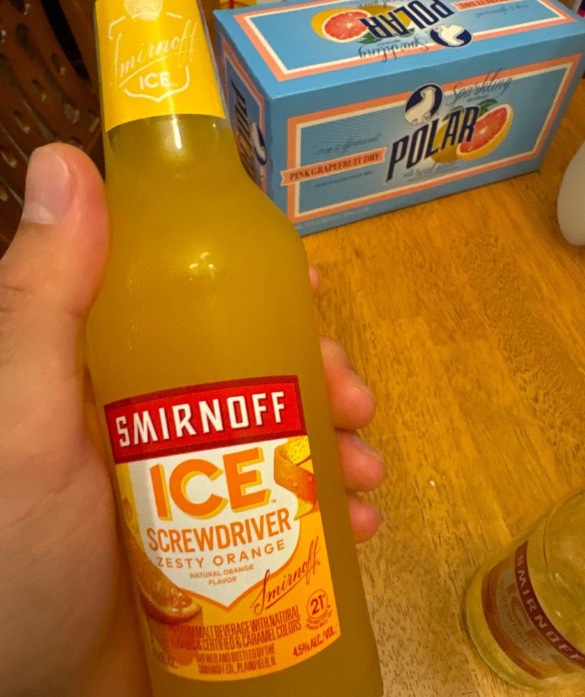 im holding a bottle of smirnoff ice screwdriver, specifically the zesty orange flavor. its fuckin delicious