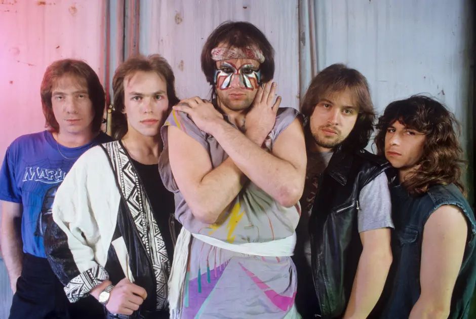 Marillion in the eighties: Fish in the centre, in outrageous facepaint and a headband, flanked by Ian Mosely, Mark Kelly, Steve Rothery and Peter Trewavas.