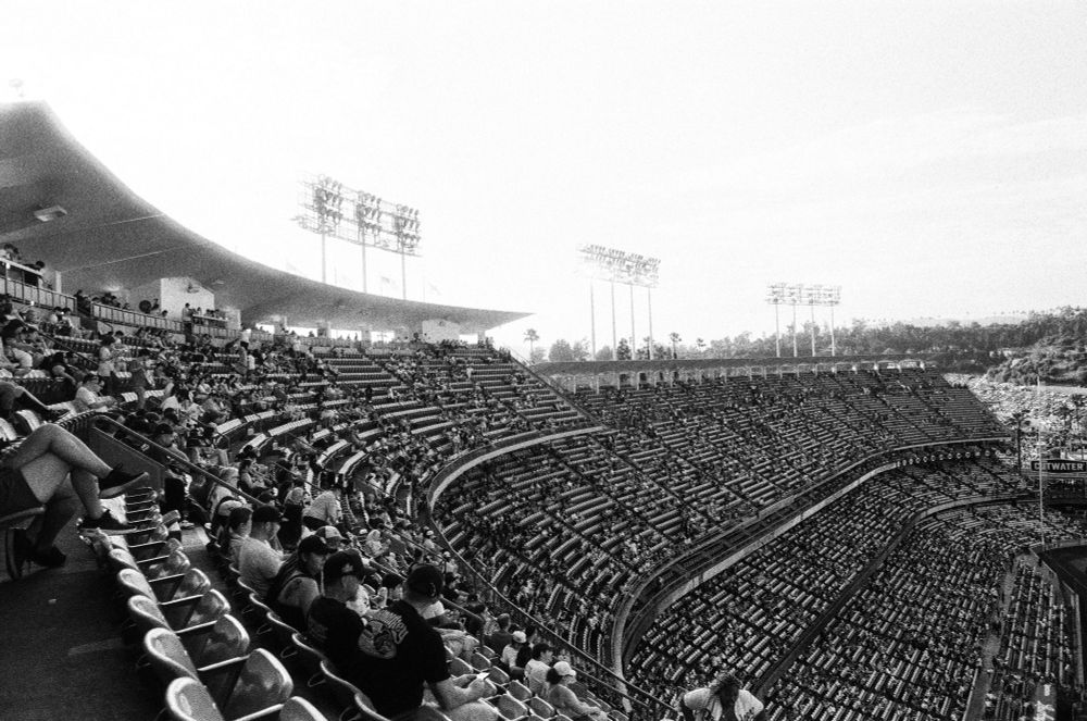 A black and white photo of the crowd of fans from the top deck section of Dodger stadium during the day