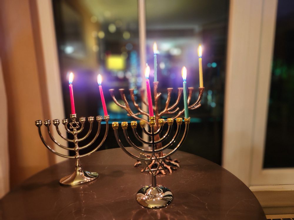 Three menorahs lit for the first night of Hanukkah