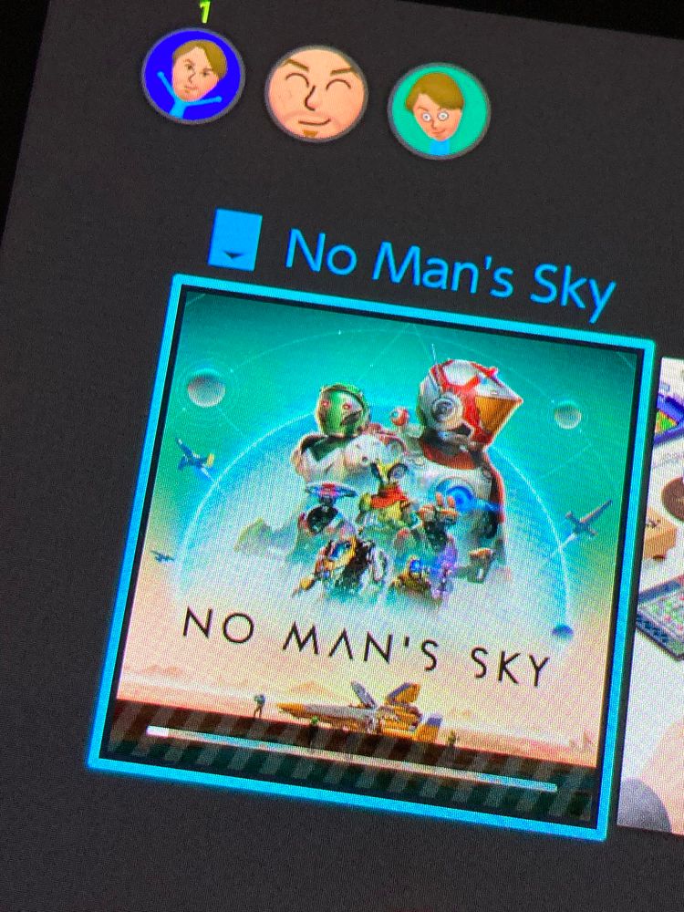 A Switch Home menu screen showing No Man’s Sky downloading after being bought  discounted, with a free Switch 2 upgrade available tmrw, on Switch 2 launch day.