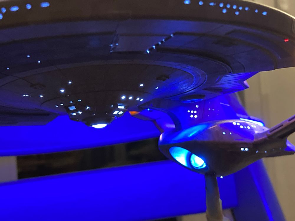 USS Enterprise G model with internal lighting, painted with windows scratched out. Lower saucer, secondary hull and deflector dish are visible.
