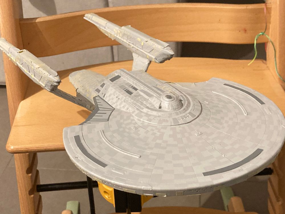 Shot of a 1/1400 scale model of the USS Enterprise G with most of the paint masks removed from the top of the saucer to reveal a subtle ‘Aztec’ pattern.