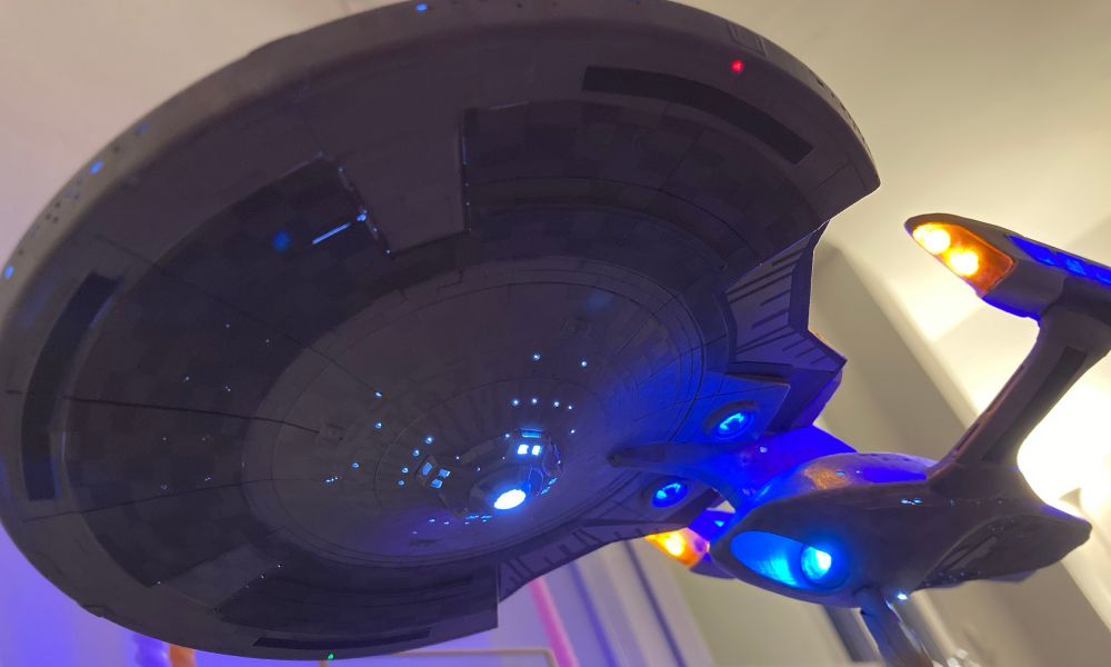 Underside of a 1/1400 scale model of the USS Enterprise G, lit with various light leaks that need fixing.