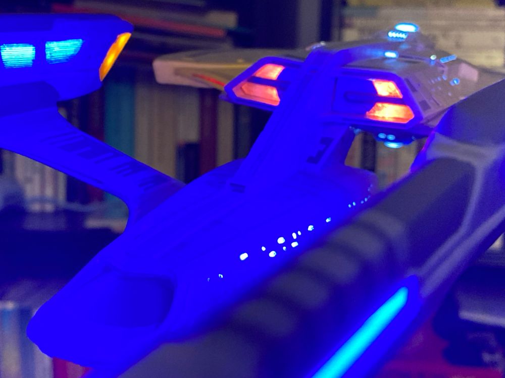 USS Enterprise G model with internal lighting viewed from behind.