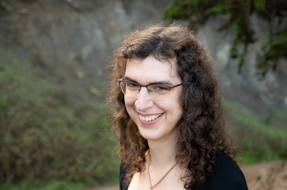 a really pretty dog girl smiling happily at the camera