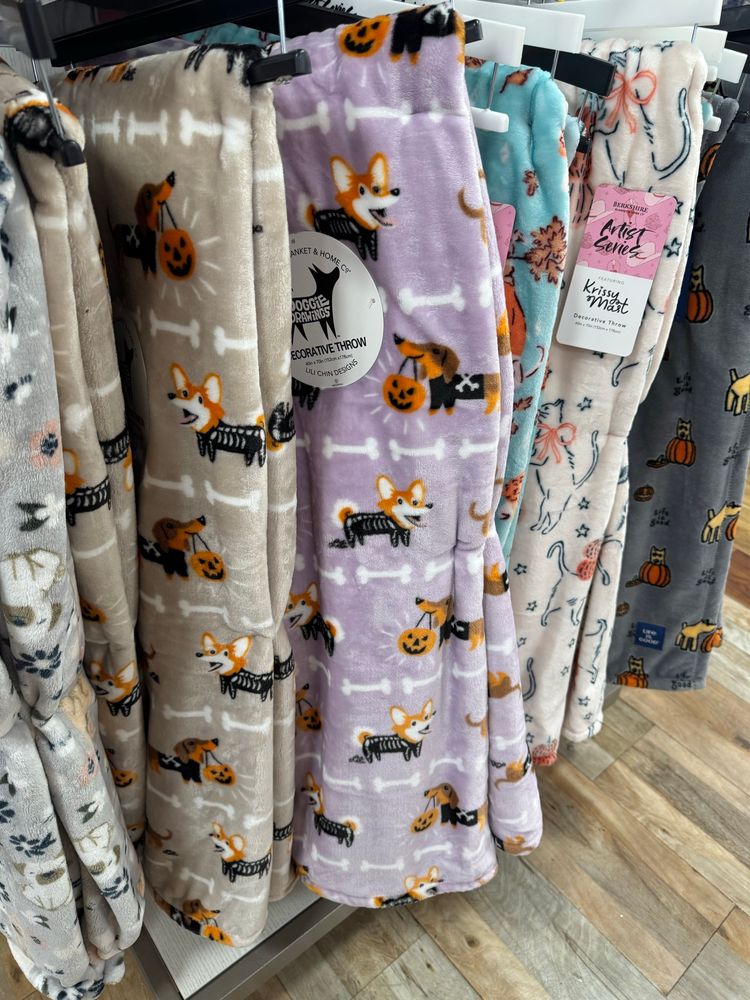 Blankets with corgis dressed up for Halloween. 