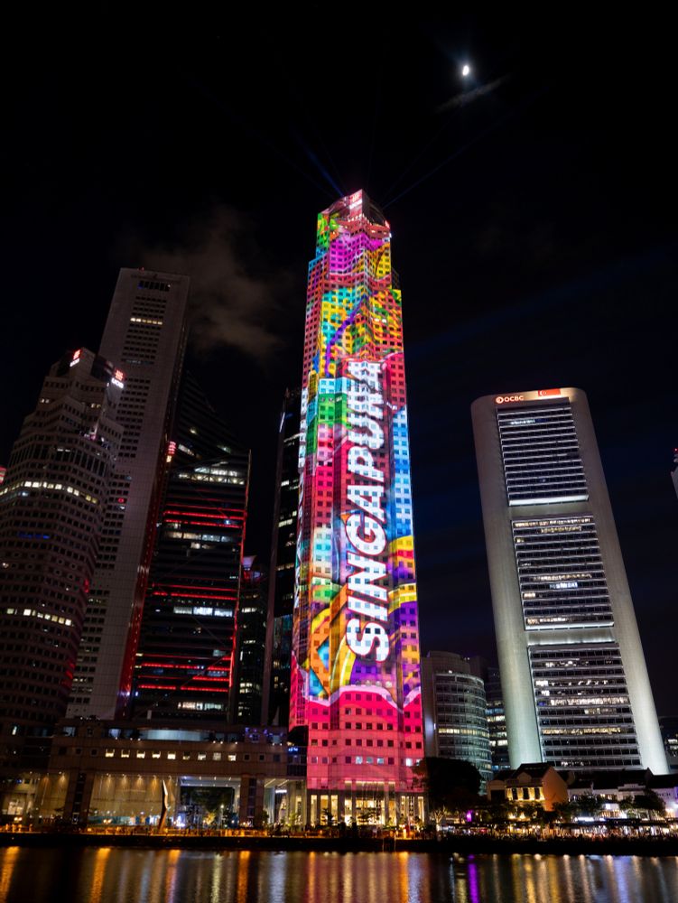 UOB Plaza One being lit up with projected images for Singapore National Day.
