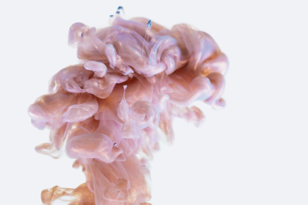 a light pink cloud of ink that loosely resembles the shape of a brain