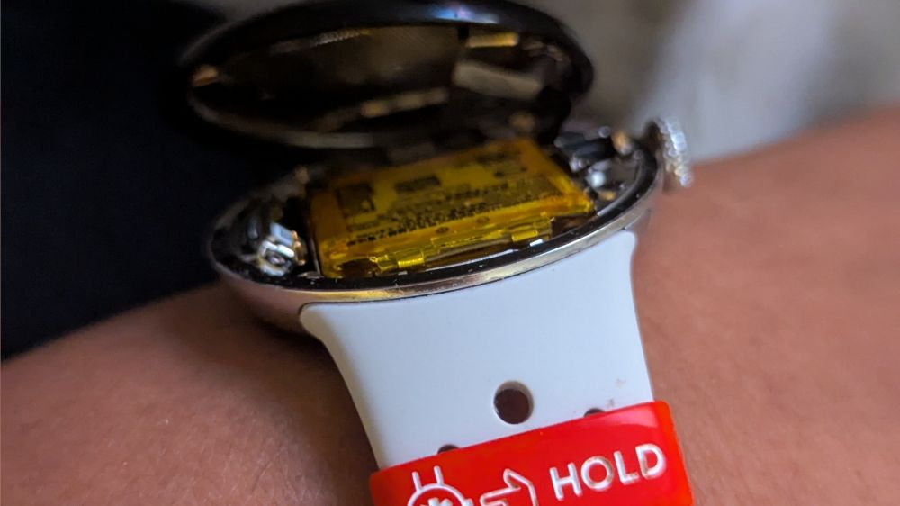 Close up on my smartwatch. You can see inside of it because the watch face is coming off.