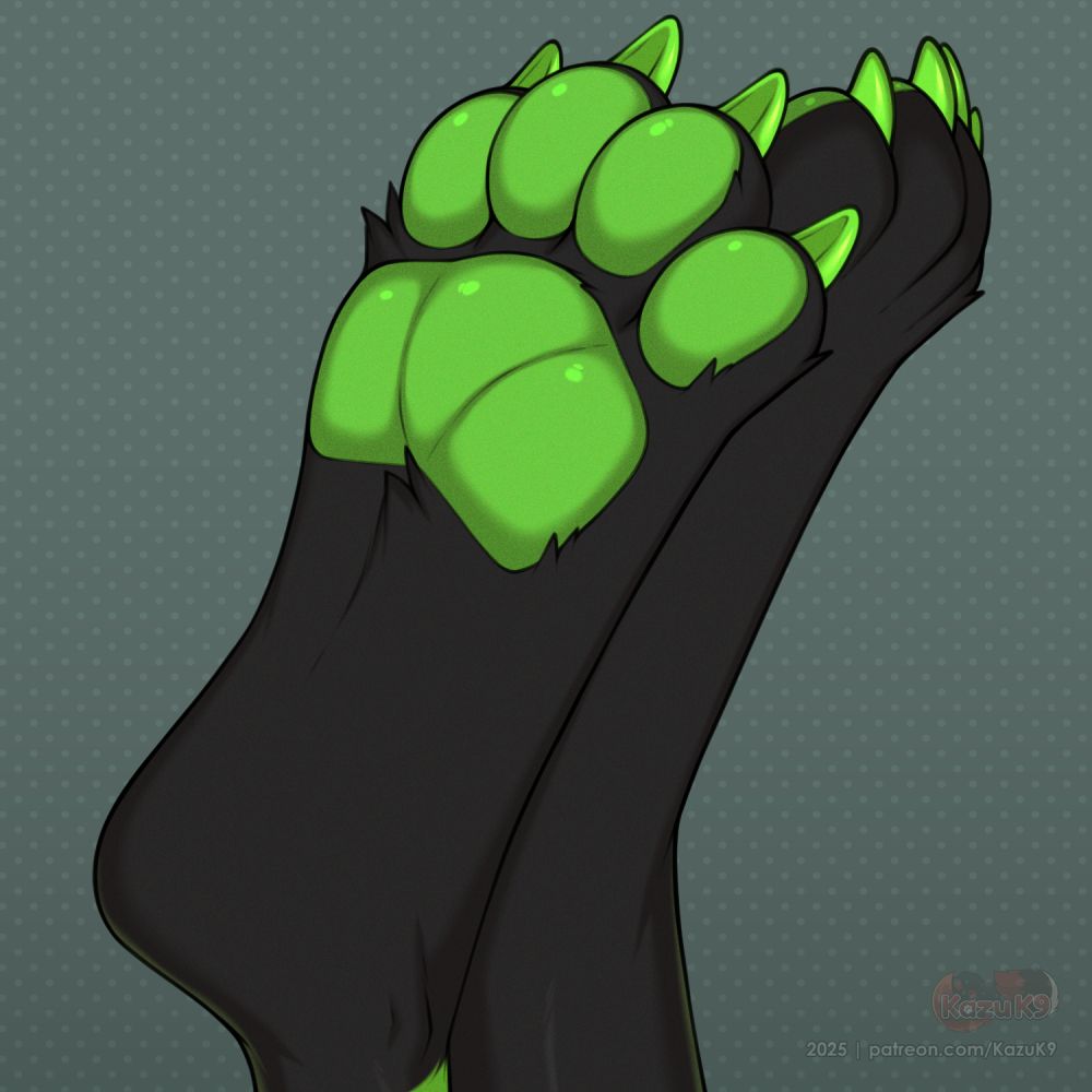 A pair of feline paws, toes pointed up in the air. You can see the black fur tuft around the plump neon green pads. 4 meaty toes end in neon green claws.