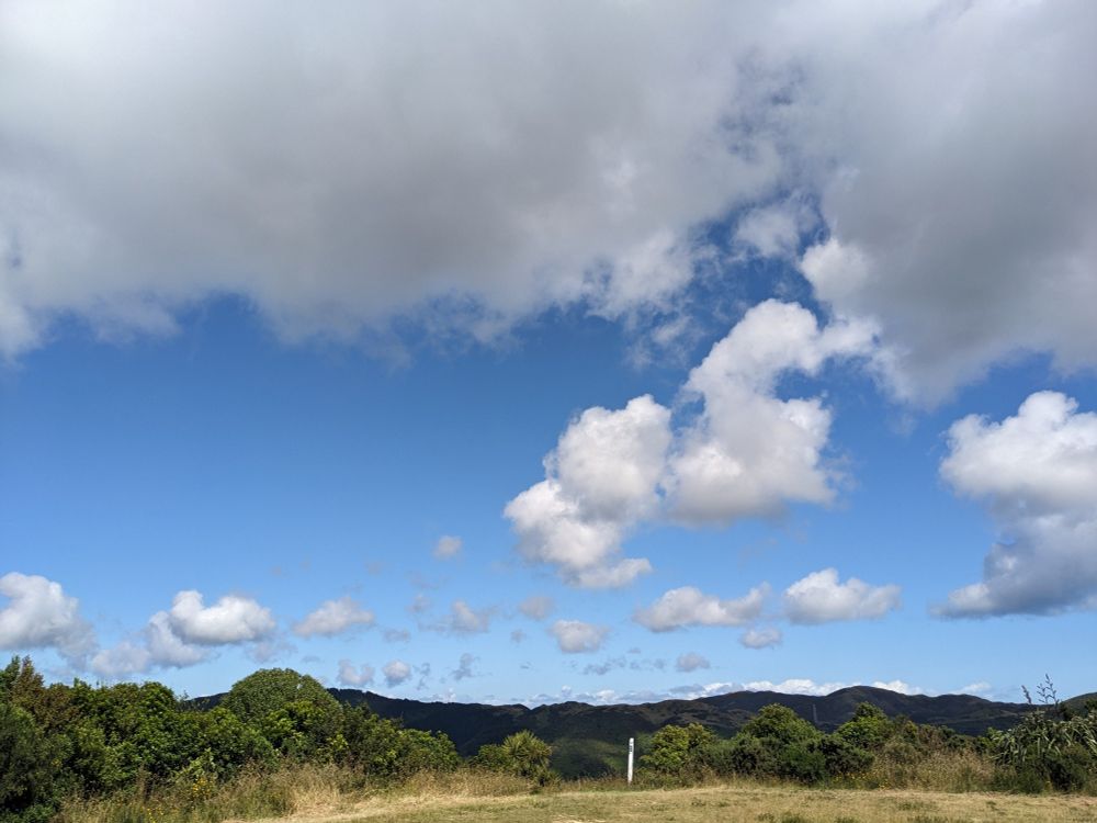 View of blue skies, cloud, hills in the distance