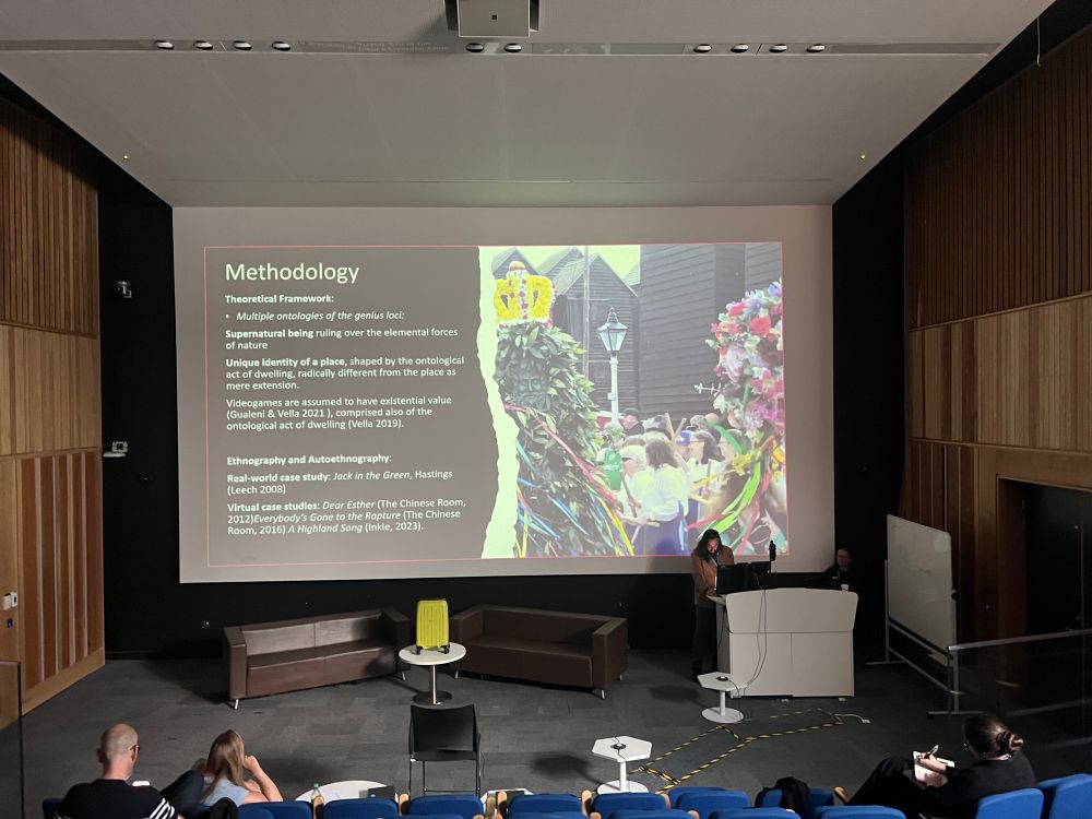 A slide being presented at a video games conference with a photo of Black Annis at the Hastings Jack in the Green festival 