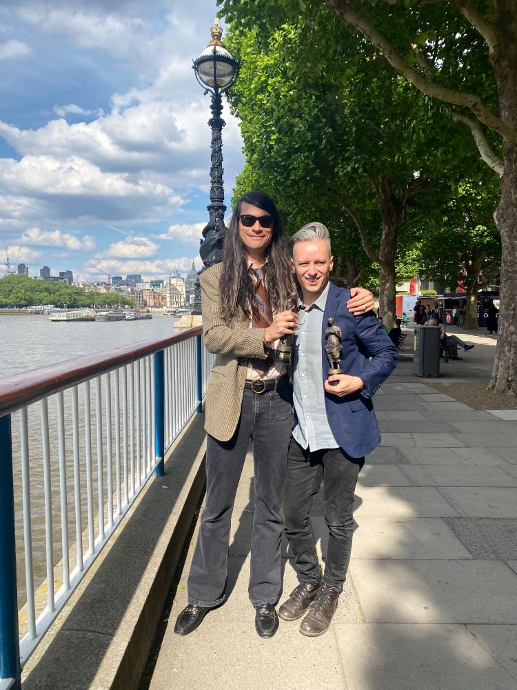 Gordon Moakes and Matt Tong holding their Ivor Novelloson the South Bank, London