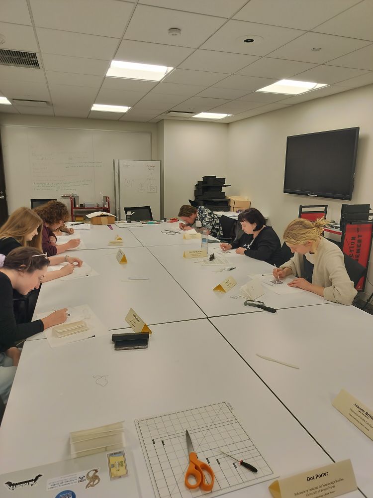 Students in Digital Codicology class sitting around the table, making their illuminated initials.