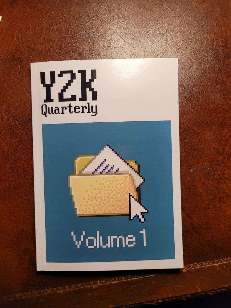 Cover of literary journal Y2K Quarterly, featuring teal square with pixelated desktop computer file icon.