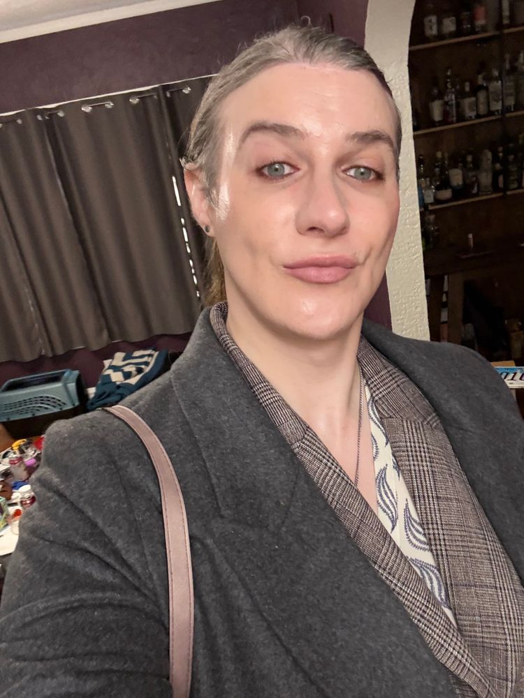 Maggie wearing plaid jacket and grey top coat