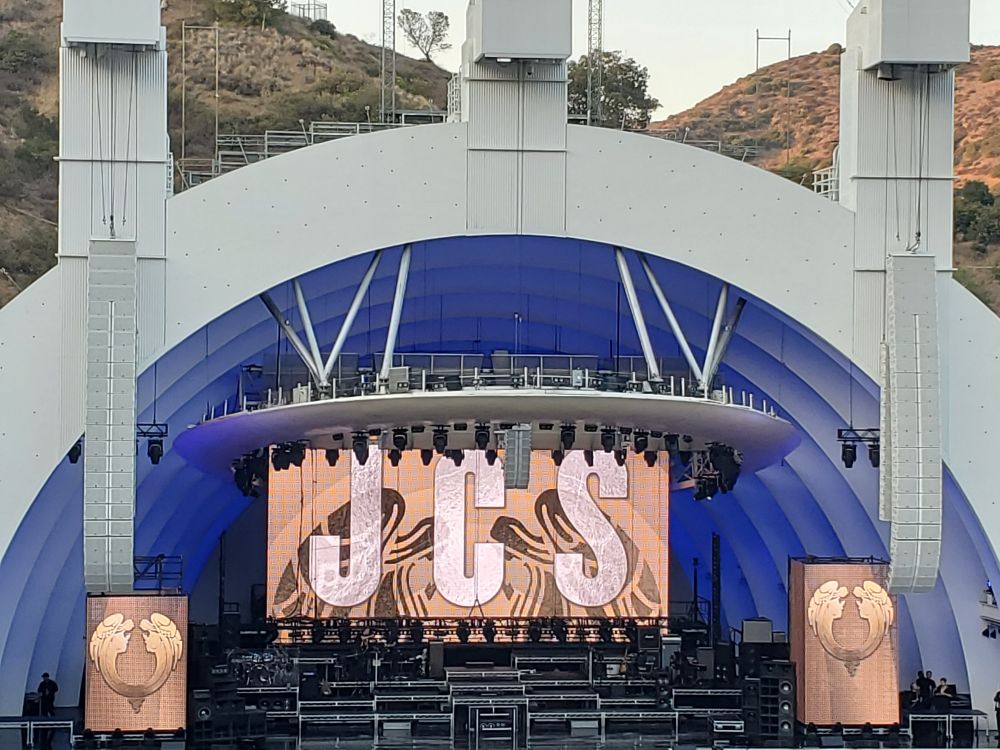 Photograph of the Hollywood Bowl, with "JCS" on the screen behind the stage. 