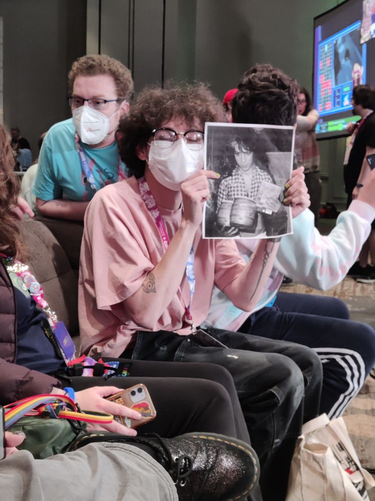 Ness with a photo of Amy winehouse with some bongos 