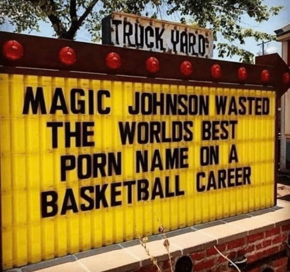 Yellow billboard with an inscription in big black letters "Magic Johnson wasted the best porn name on a basketball career".