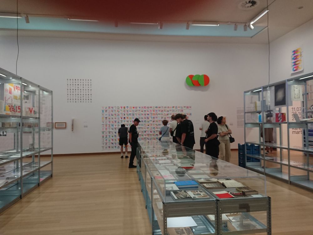 Room in a museum with displays with modern graphical art and books