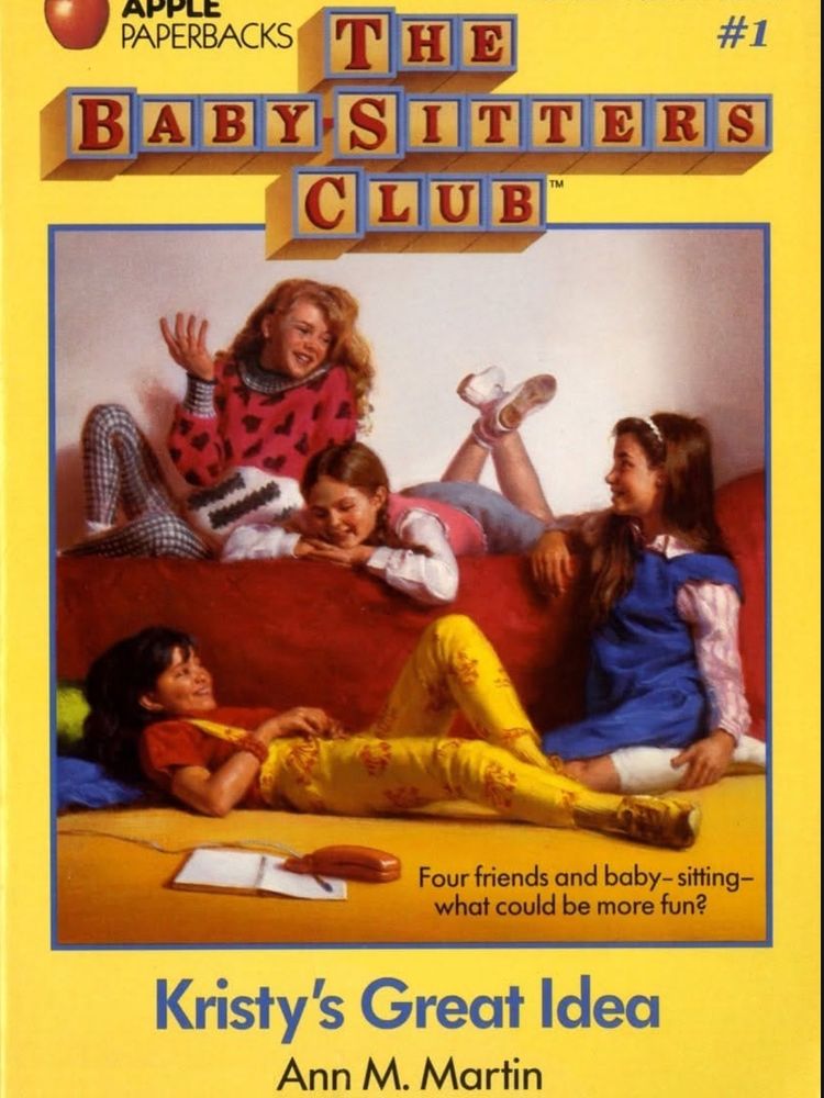Cover of The Baby-Sitters Club #1: Kristy’s Great Idea by Ann M. Martin. The illustration shows four girls—Kristy, Claudia, Mary Anne, and Stacey—gathered around a bedroom, sitting on the floor and a bed, surrounded by notebooks and snacks. They look like they’re in the middle of planning something important. The title is in bold yellow letters, with the classic red-and-blue BSC logo at the top.