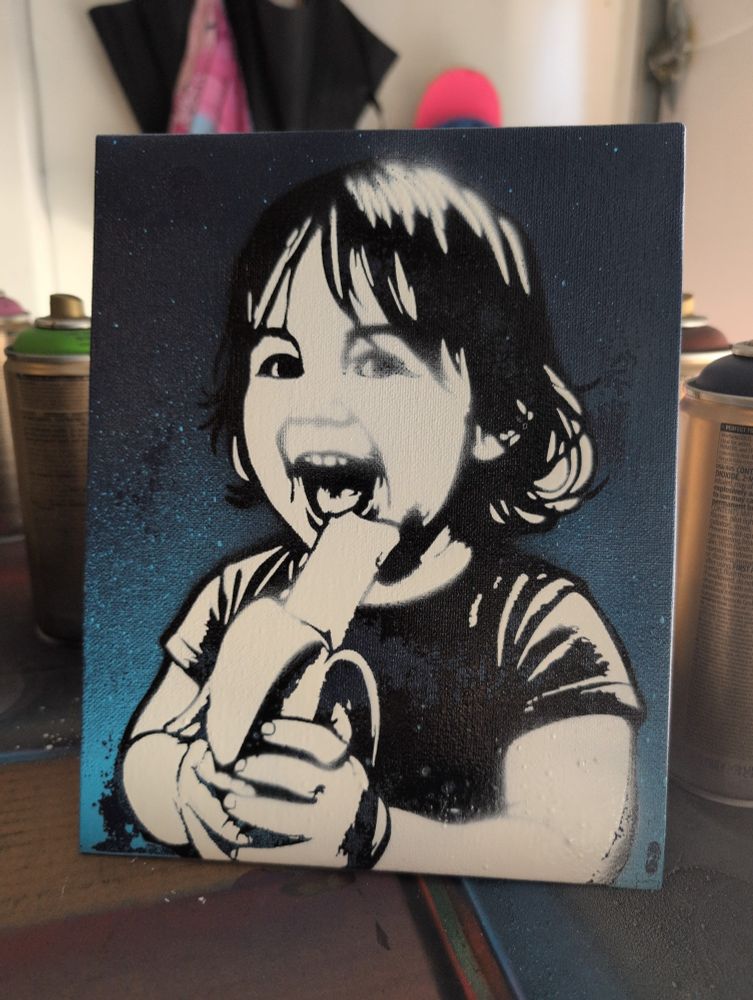 Spray paint stencil art of a little girl adorably excited about her banana 