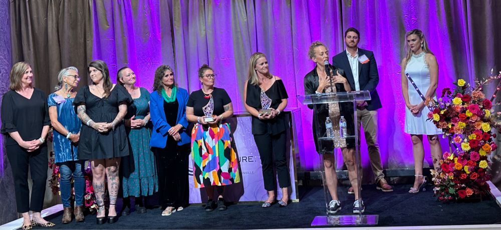 Rethreaded CEO Kristin Keen at the podium accepting the award.
