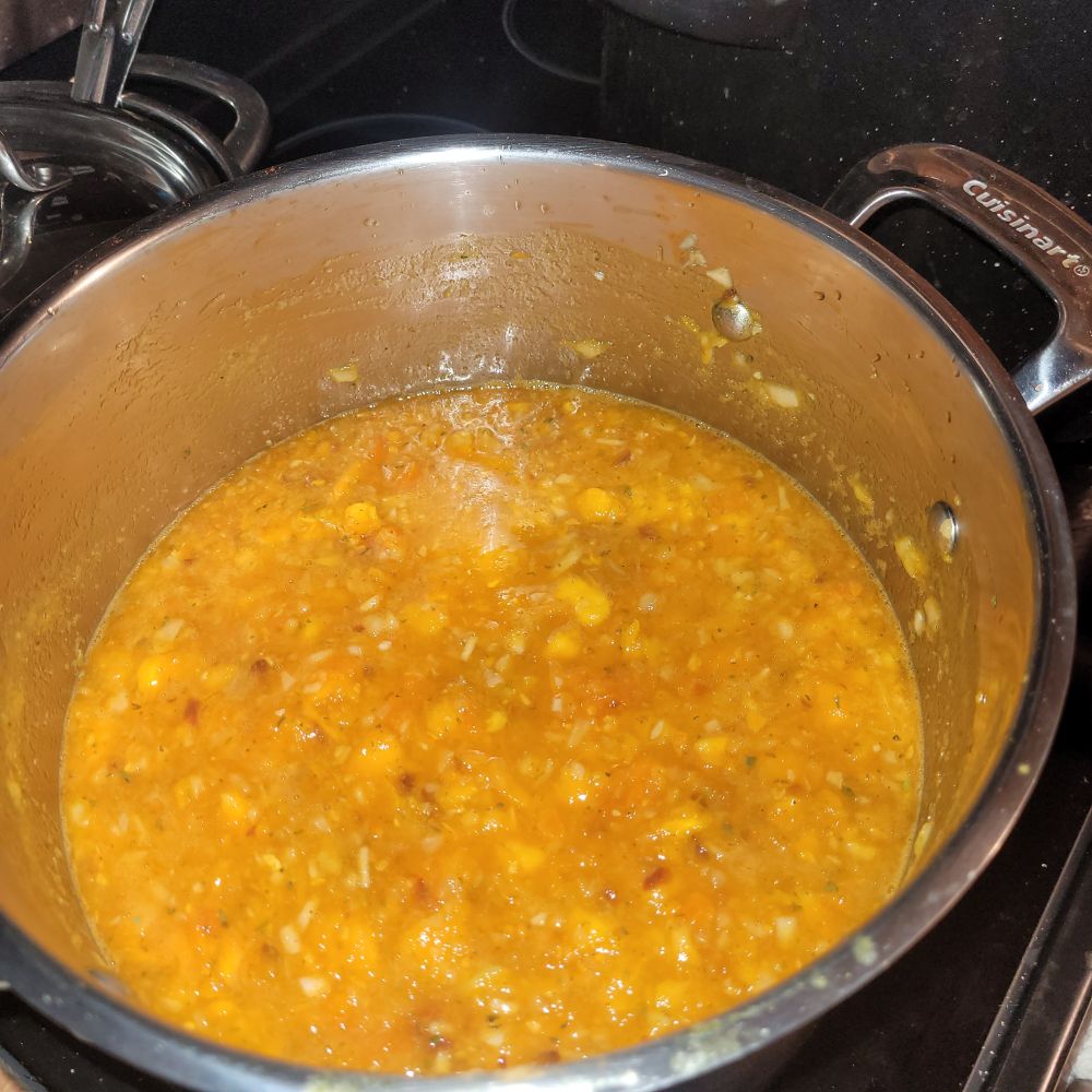 A pot of gold salsa made from Lemon Boy tomatoes, yellow peppers, yellow scotch bonnets, onions, cumin, smoked paprika and cilantro.