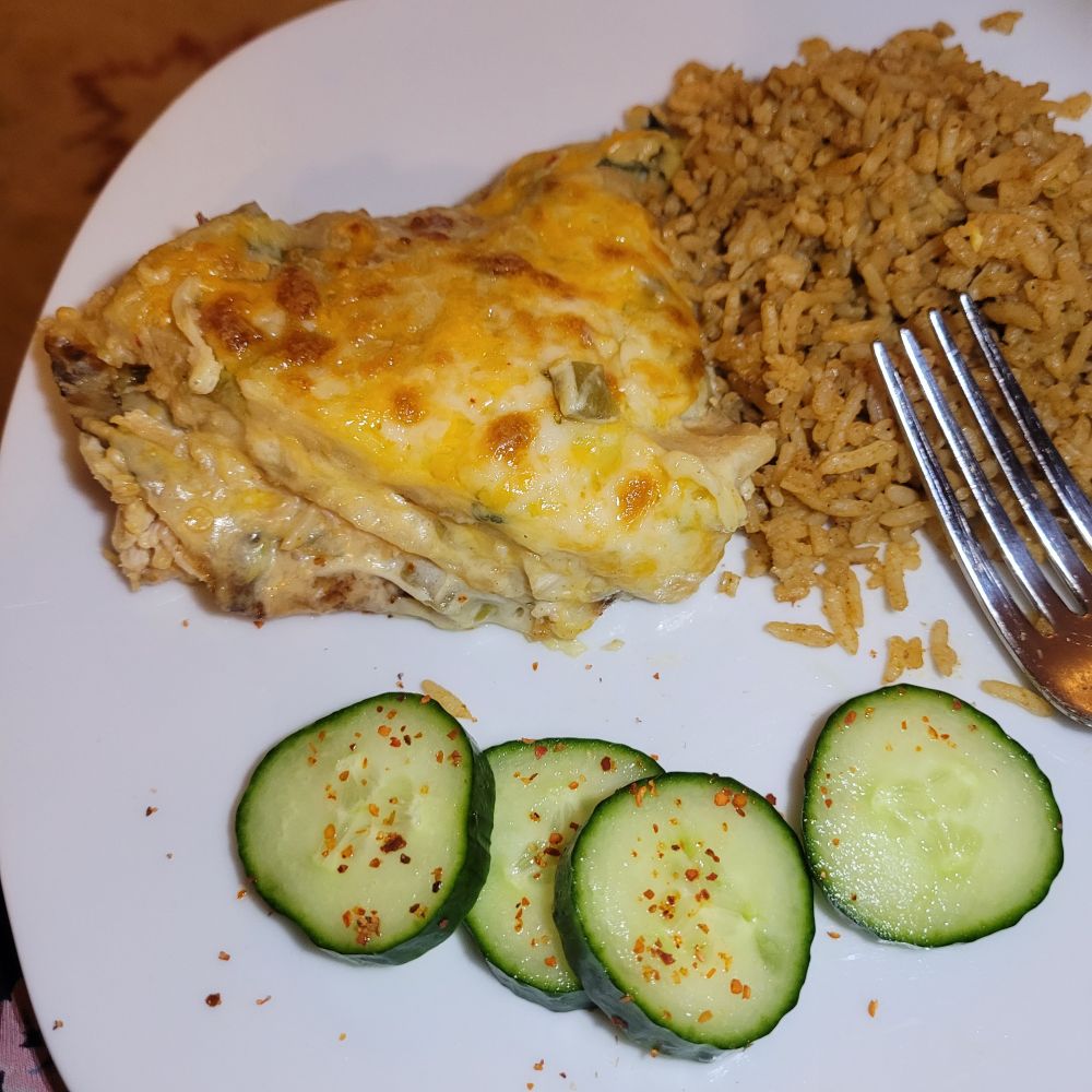 Chicken and green chili tortilla casserole, mexi rice and cucumber sprinkled with Tajin spice