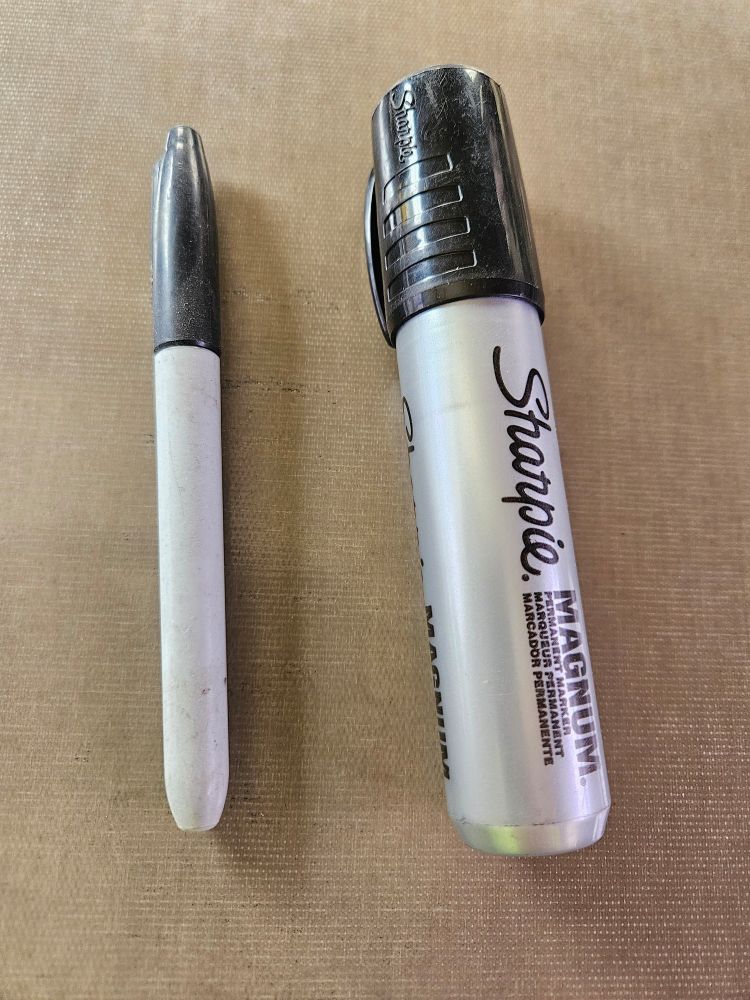 Regular sized sharpie next to a magnum sharpie 