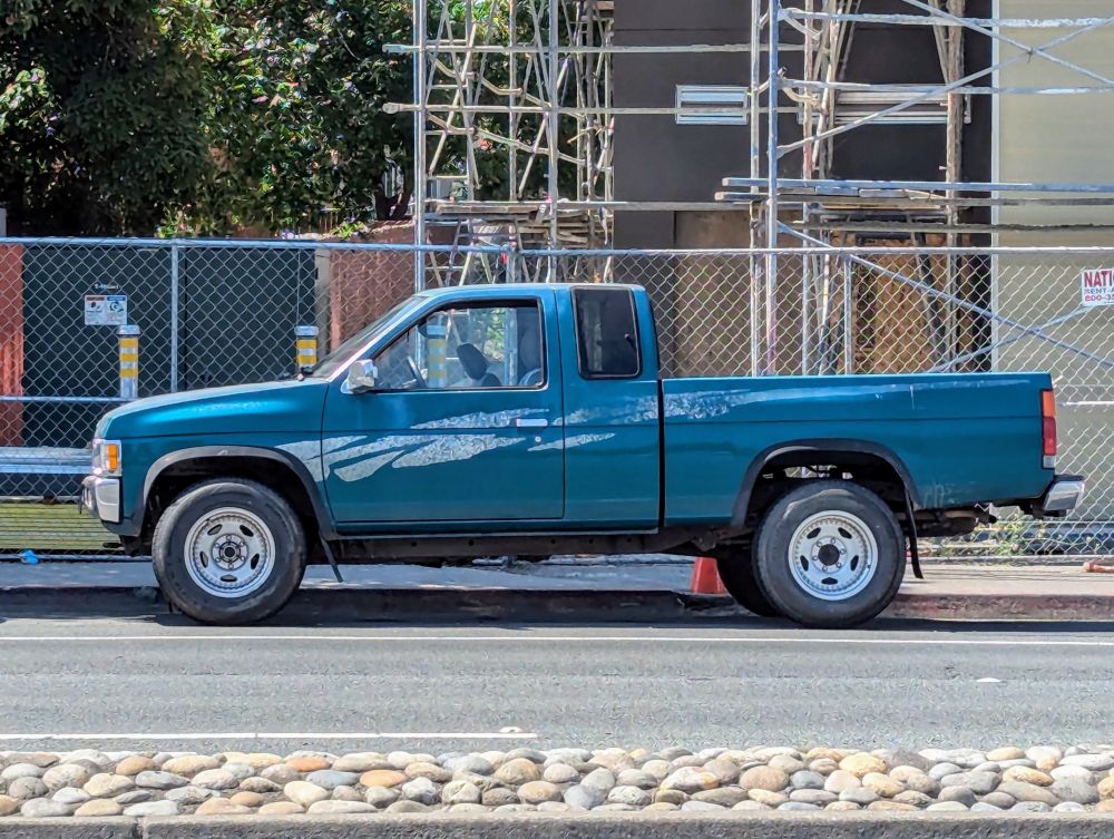 90s Nissan Hardbody street parked - teal with side graphics