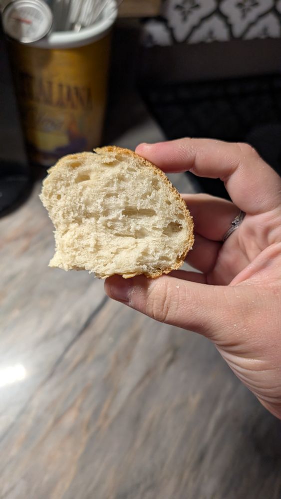 Showing off the inside of a slice of the French bread it's very airy with a crisp outside 