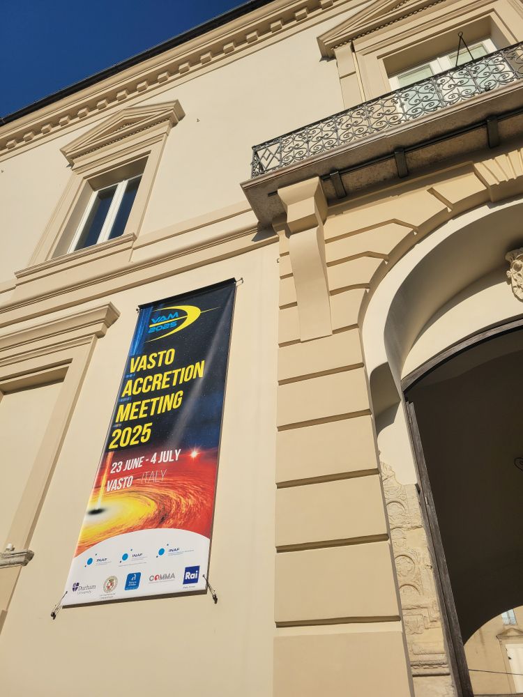 view up at the facade of a building with a banner for the Vasto Accretion Meeting