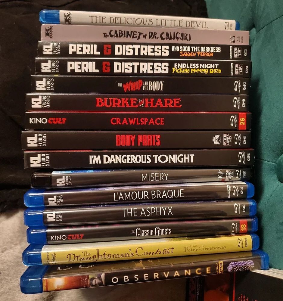 A generous stack of Blu-ray and 4K UHD cases for cult, horror, thriller, and silent films; I'm too undercaffeinated right now to type out all the titles, sorry