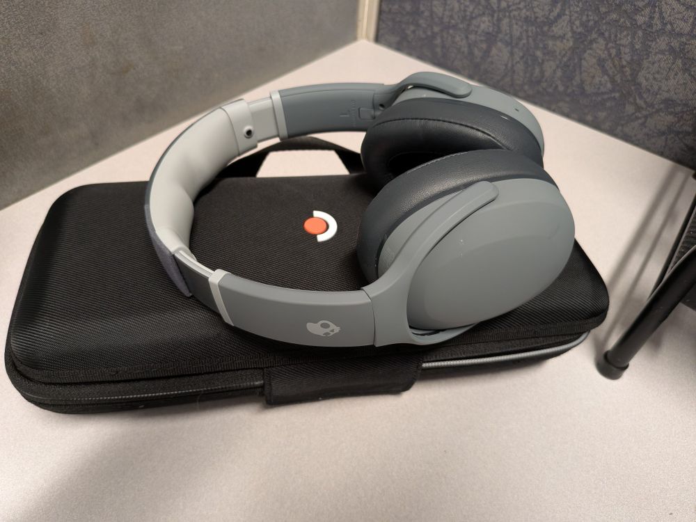 Steam deck case with headphones on top of then.. 