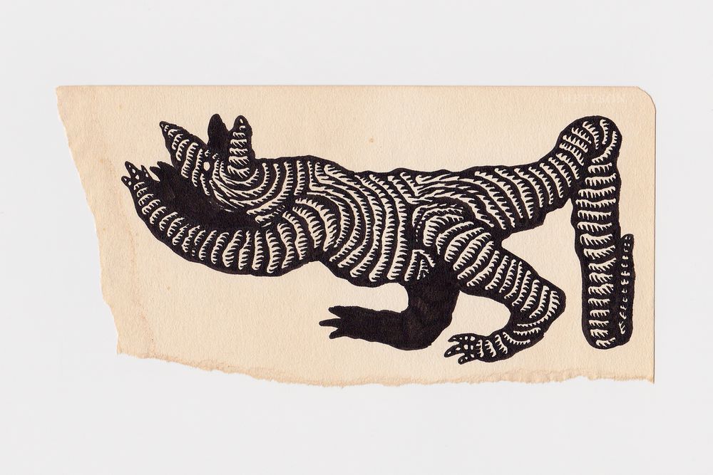 A scrap paper stained with coffee that has a drawing of a quadrupedal creature. It's vaguely canid in form and has a long tail. The creature is constructed from a rope or tube-like material.