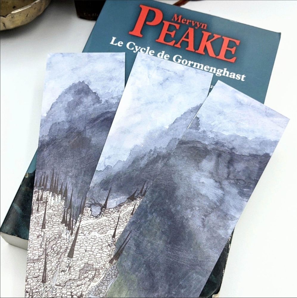 Mervyn Peake's Gormenghast illustrated bookmarks by french illustrator Lucy Dreams.
Whimsical and mesmerising watercolour and ink illustration printed on three bookmarks.
The large Gormenghast castle with its multitude of towers is drawn in Indian ink and dominated by mountains shrouded in mist, painted in watercolour.