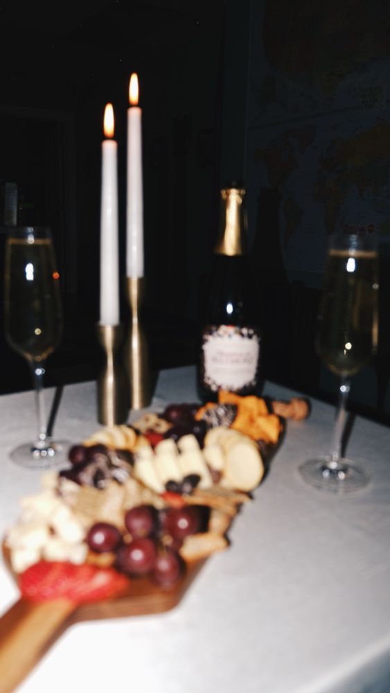 charcuterie and champagne in a candlelight setting