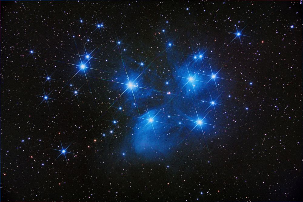 the Pleiades showing colorful diffraction spikes